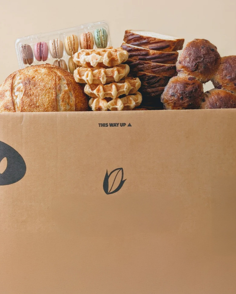 Wildgrain delivery box filled with bread, waffles, pastries and macarons